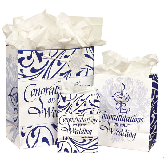 Celebrate the sacrament of matrimony with these beautiful bags. The large and small bags feature a blue filigree design around the message &quot;Congratulations on your Wedding.&quot; The sides feature a religious wedding symbol (two flowers and rings joined in a Chi Rho) in dark blue. In the background is a light blue woodcut image of a bouquet of wedding flowers. On the medium bag, the wedding symbol is on the front and back, while the sides are covered with the reverse of the filigree design