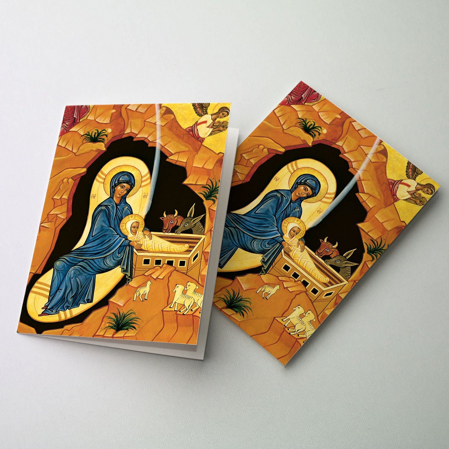 Cropped image of the Nativity from our icon, M08 by Sister Marie Paul, O.S.B. A Great Value! 20 Cards, 21 matching envelopes. * Convenient 4.38&quot; x 5.93&quot; size * Many cards feature hand-done lettering * Appropriate Bible verse included * Quality white envelopes