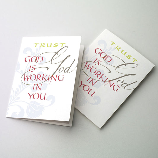 &quot;Trust God is Working in You&quot; in gray, dark red and chartreuse on a white ground with a light gray floral pattern in background.