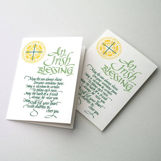 Green lettering on white background with Celtic cross