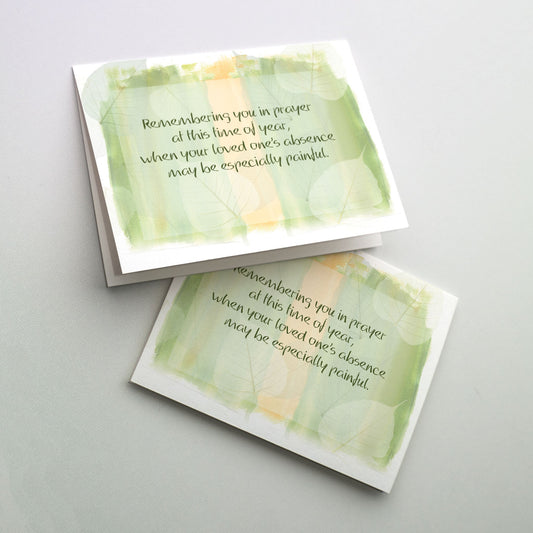 This card offers comfort and support around the anniversary of a death, which can trigger stronger memories. Soft green and coral background with soft leaves and cover text.