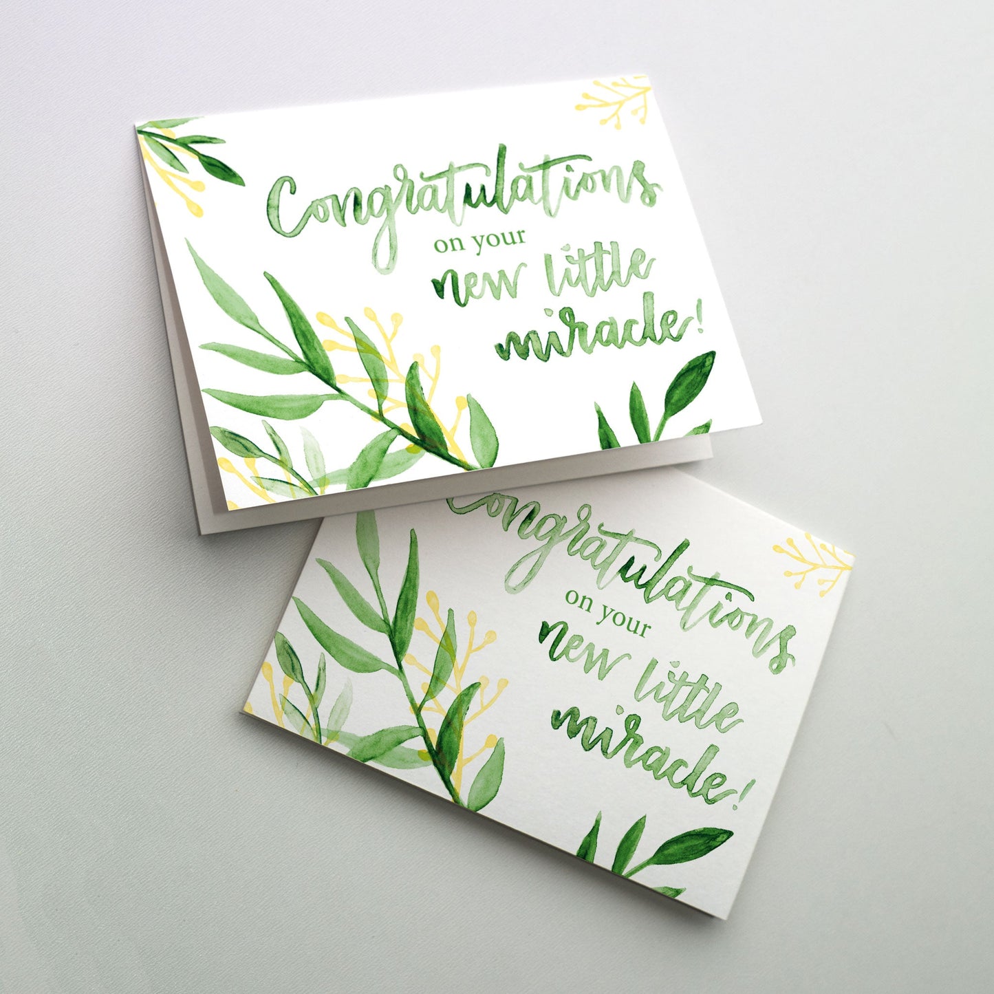 Calligraphy set amidst growing greenery. This card is suitable for birth after a difficult pregnancy or when a couple had difficulty conceiving.