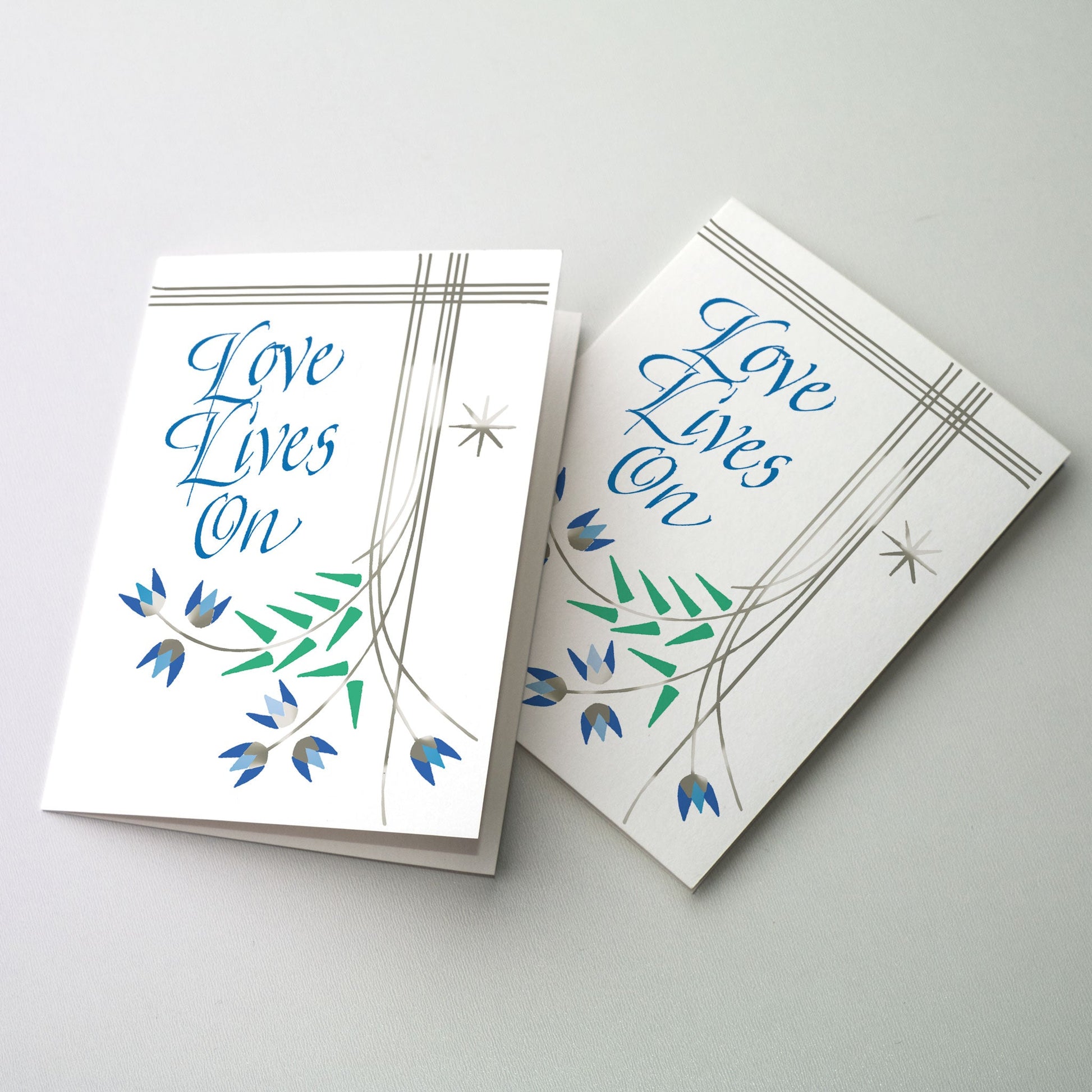 Delicate silver linework flowers with blue calligraphy