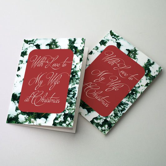 A background of green conifers covered with snow with scripted cover text centered on a Christmas romantic red background