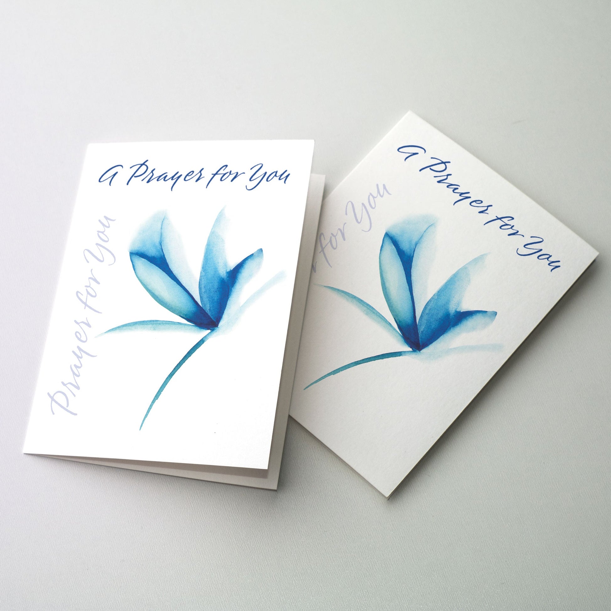 Express your thoughts of concern and prayer in calligraphy accented by a blue flower. The cards measure 5&quot; x 7&quot;. Printed on recycled paper.
