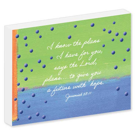 Bright blue and green background with blue dots featuring Bible verse on white block.